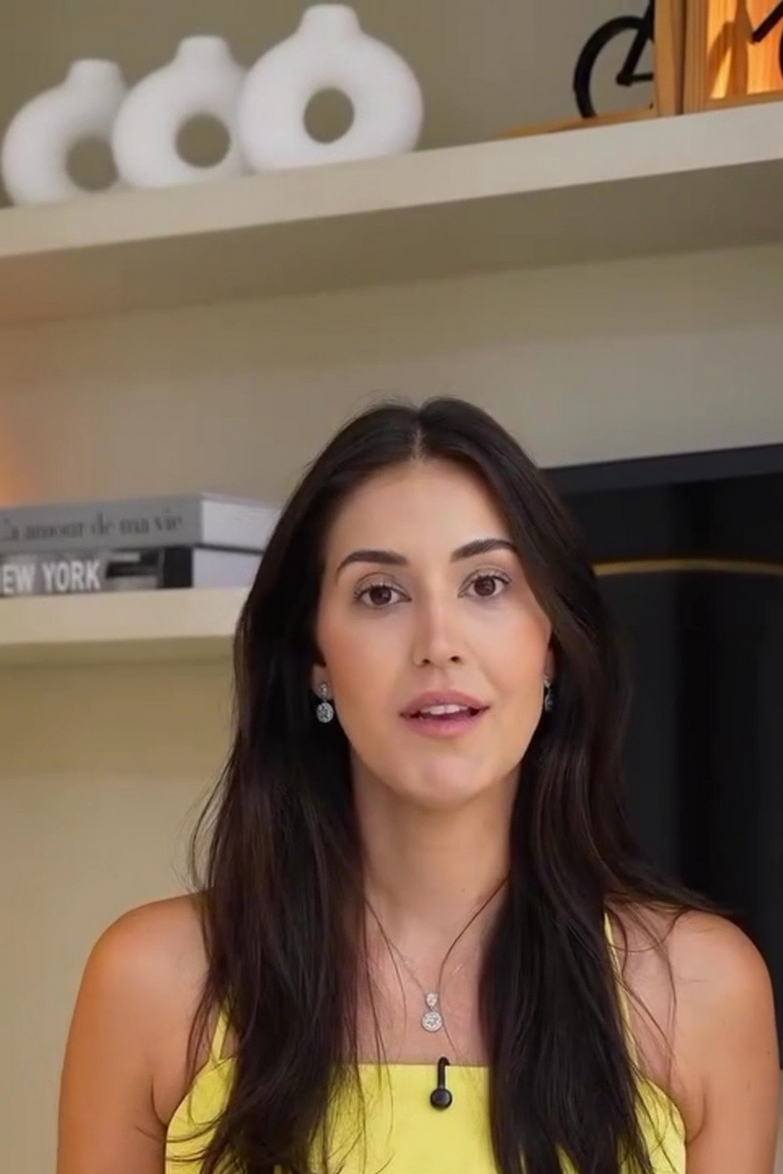 Retrato da Dra. Fernanda Bessa, dermatologista, sorrindo em fundo neutro